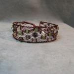 12 strand Lace and peridot bracelet in Enameled copper.  Handknotted and woven, copper does not need polish.  1" wide, easy clasp.  specify size.  $75.00