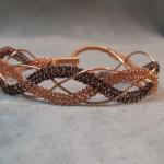 Copper and enameled copper lace bracelet.  Called 2 knotty for the two strands of hand knotted wire.  Lacquered will not tarnish.  Specify Size.
$75.00